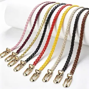 Close-up detail of stylish women's braided thin belt with golden metal buckle, set.