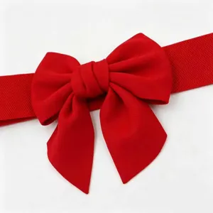 Detailed view of a bright red high-elastic waist belt with a large decorative bow element.