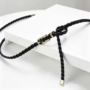 Detailed view of the black braided thin belt featuring a sleek gold-tone metal buckle.