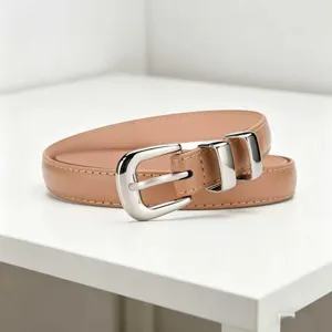 Detailed shot of a sleek women's slim leather belt with a polished silver-tone metal buckle.
