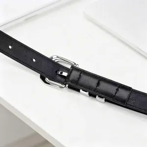 Minimalist black women's leather belt with polished silver buckle detail for daily wear.