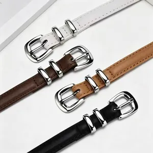 Detail view of minimalist women thin leather belts in four colors with silver buckles.