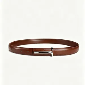 Closeup of minimalist brown leather belt with silver buckle for stylish women's outfits.