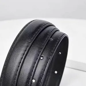 Close-up detail of women's black leather belt showcasing neat double stitching and texture.