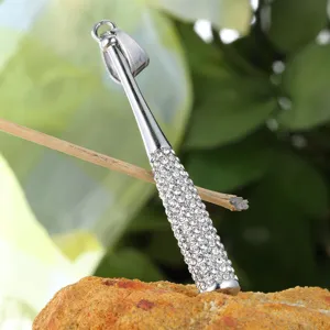 Detailed view of iced out rhinestone texture on silver hip hop baseball bat pendant
