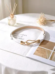 Detailed view of the women's white PU thin belt with a sleek gold-tone metal hook buckle.