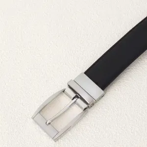 Close-up of a men's black leather belt with a polished silver rectangular pin buckle.