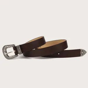 Close-up detail view of the vintage carved metal buckle on dark brown fashion belt.