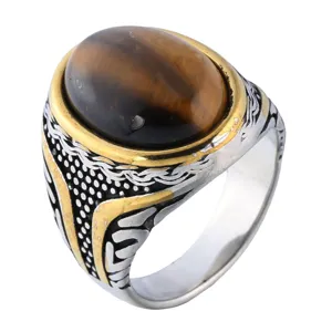 Detailed view of a vintage titanium steel ring featuring a polished oval tiger's eye stone