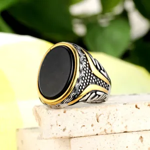 Vintage stainless steel ring with large oval black gemstone and golden rune details