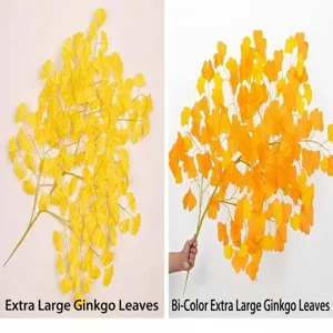 Close-up comparison of solid yellow and two-tone artificial ginkgo leaf branches