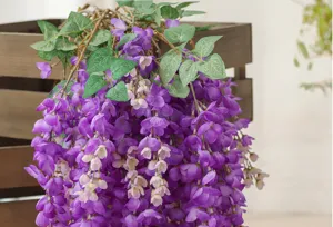 Detailed close-up showing hanging artificial purple wisteria flowers for wedding decor