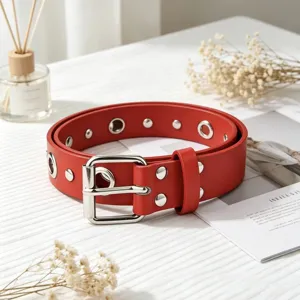Red punk style double row grommet leather belt for women, adjustable versatile waist accessory.