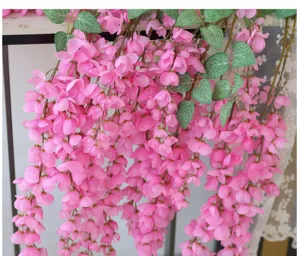 Detailed view of artificial pink hanging wisteria flowers for wedding and party decor