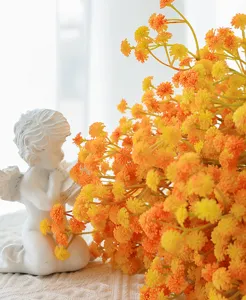 Artificial baby's breath flower bouquet detail shot with angel figurine decor for home.