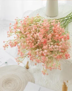 Close-up detail of pink artificial gypsophila flowers bouquet for home decor scene.