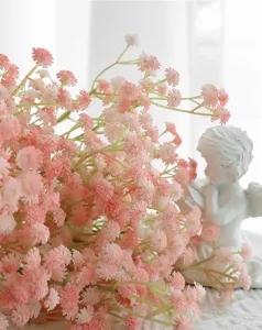 Detail shot of pink artificial baby's breath bouquet with angel decor for home room decoration.