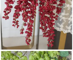 Detailed view of red and green artificial wisteria hanging flower vines for wedding decor