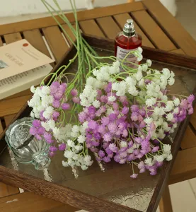 Artificial baby's breath bouquet detail, white and purple silk flowers for home decor.
