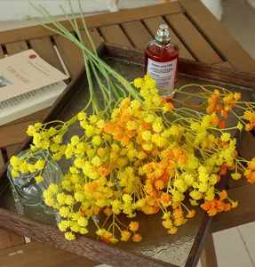 Close-up detail of artificial yellow gypsophila flower bouquet, perfect home decor arrangement.