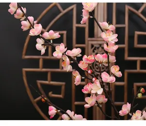 Detailed close-up of artificial pink plum blossom branches, perfect floral home decor.