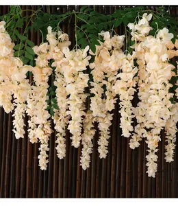 Macro view of realistic artificial hanging wisteria vines in a cream peach hue