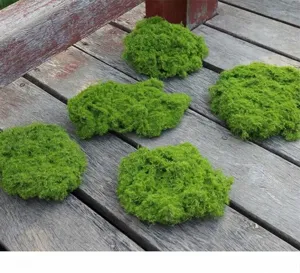 High-detail close-up of realistic artificial moss blocks on a rustic wooden deck surface