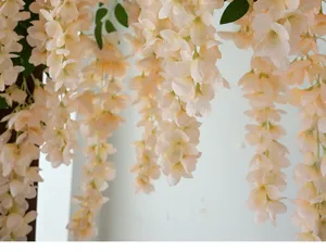 Close-up of elegant cream champagne artificial wisteria flower vine for home decor