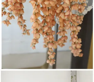 Detailed close-up of artificial orange wisteria silk flower vine for wedding decor
