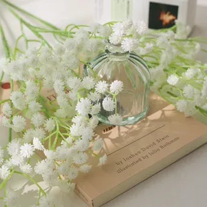 Artificial baby's breath flowers in glass vase for home decor wedding table decoration.