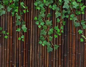 Detailed close-up of artificial ivy leaves on bamboo fence for garden decoration