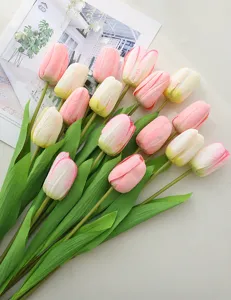 Detailed view of artificial tulip flowers, realistic pink and white bouquet for home decor.