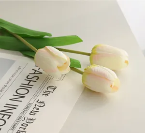 Detailed close-up view of artificial wet-feel tulips on a stylish modern tabletop background.