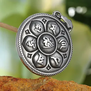 Detailed close-up of a vintage lotus pendant featuring engraved Buddhist mantra symbols