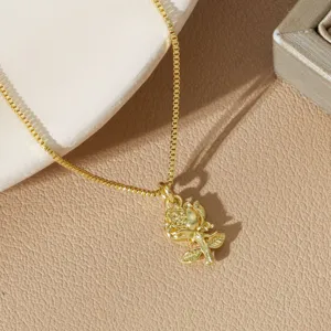Detailed close-up of an intricate gold-plated rose flower pendant on a dainty box chain