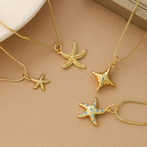 Set of elegant gold plated starfish pendant necklaces for women on leather background