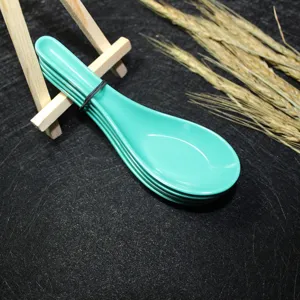 Detail view of stackable turquoise melamine Chinese soup spoons on a wooden display stand