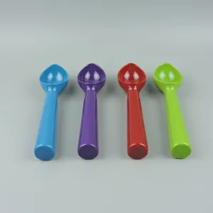 Detail view of colorful plastic ice cream spoons, blue, purple, red and green, smooth handle.