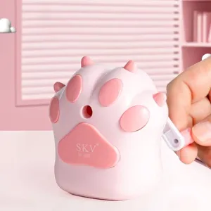 Detailed view of a cute pink cat paw manual pencil sharpener featuring a hand crank mechanism