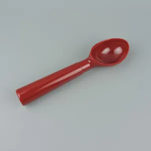 Red melamine ice cream scoop and lemon muddler tool with long handle for kitchen use.
