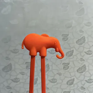 Orange silicone elephant training chopsticks for kids, cute animal design for toddler learning.