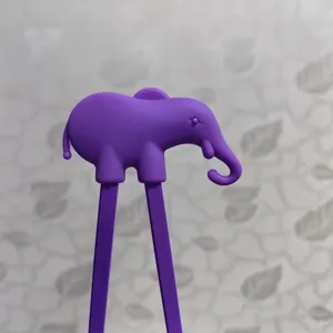 Close-up detail shot of purple silicone elephant training chopsticks top for kids learning use.