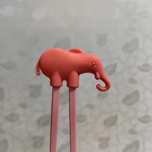 Cute elephant silicone head detail shot of children training chopsticks, safe and durable.
