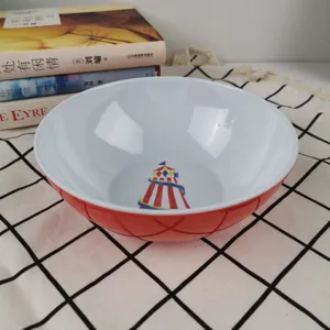 Detail shot of the red and white melamine salad bowl featuring a cute cartoon tent pattern inside.