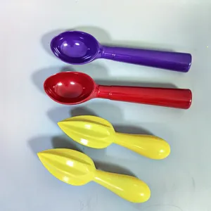 Close-up detail view of colorful melamine ice cream scoops and citrus squeezers utility tools.