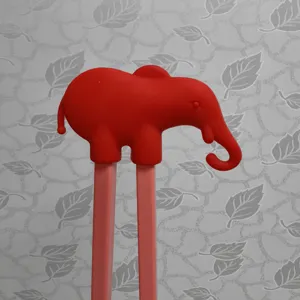 Kids training chopsticks with cute red elephant silicone topper, ideal for baby learning.
