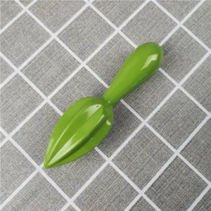 Close-up view of the glossy green manual lemon juicer reamer detail for kitchen use.