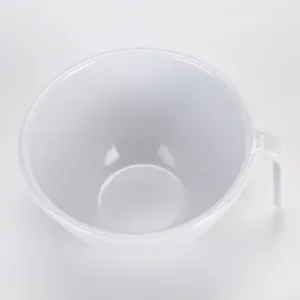 Close-up detail of white melamine mixing bowl featuring side handle and outer ribbed design.