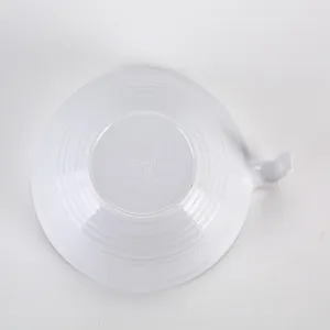 White melamine bowl bottom detail view showing heat resistance and brand markings clearly.