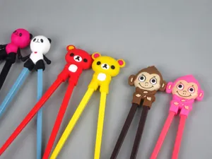 Close-up of various colorful cartoon animal themed learning chopsticks for children